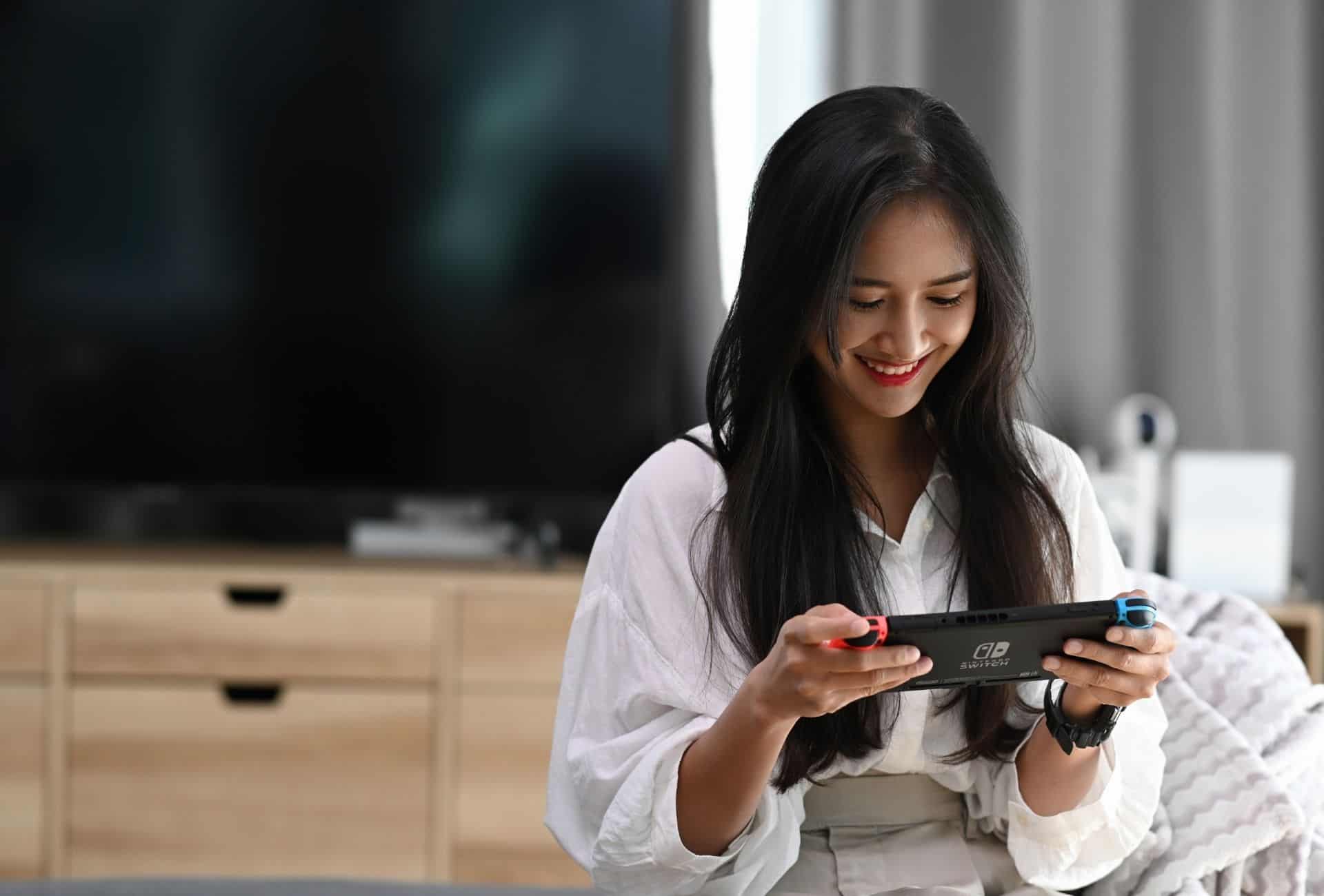 Woman playing animal crossing on nintendo switch.