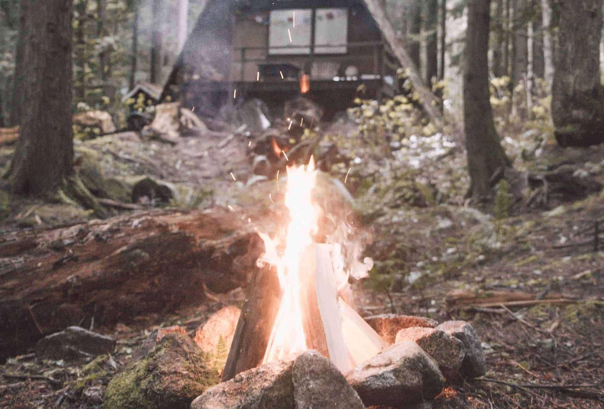 Fireplace in front of a cabin.