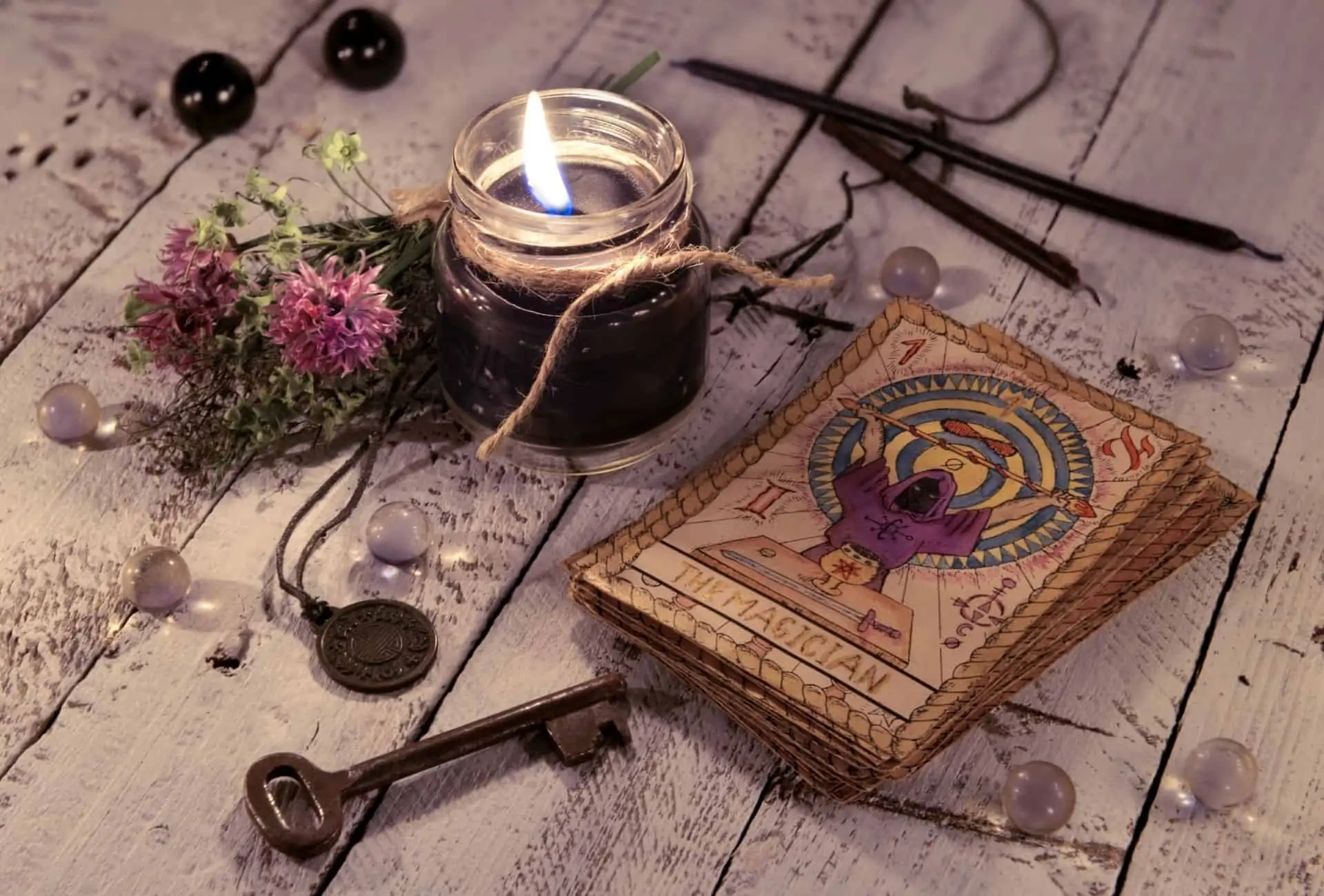 Witchy table with candle and tarot cards.
