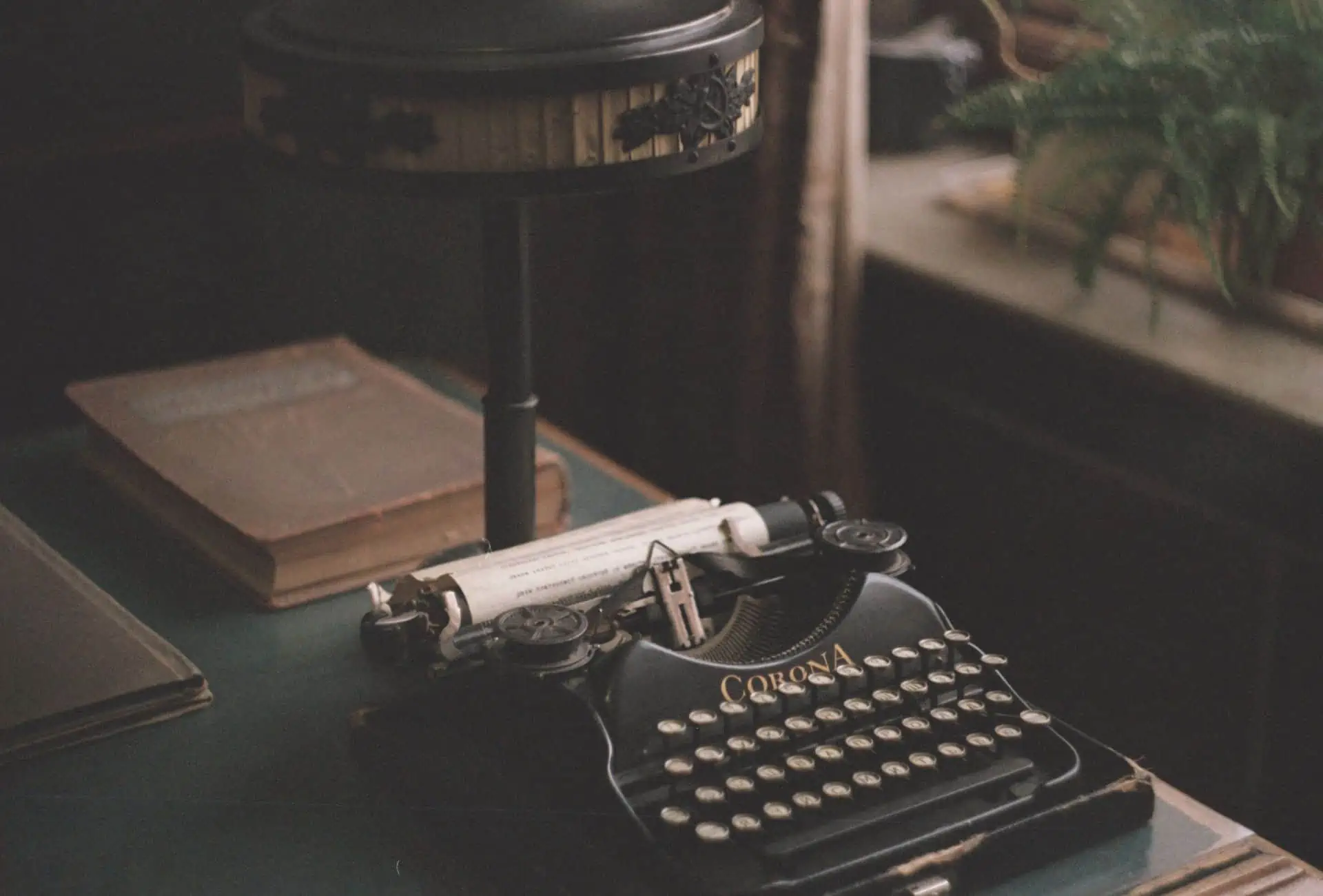 Black, vintage typewriter in a dark office.